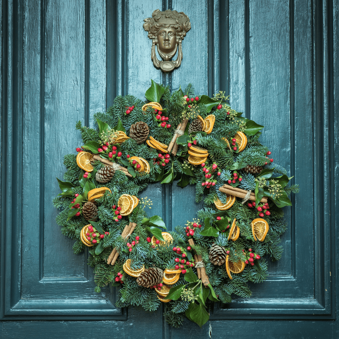 Green front door with beautiful Christmas wreath